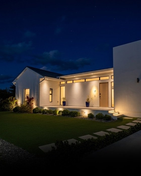 J&R Construction home entrance at dusk, Grand Cayman
